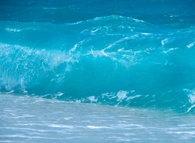 Beautiful foam waves on a sunny day in the Aegean Sea on the island in Greece