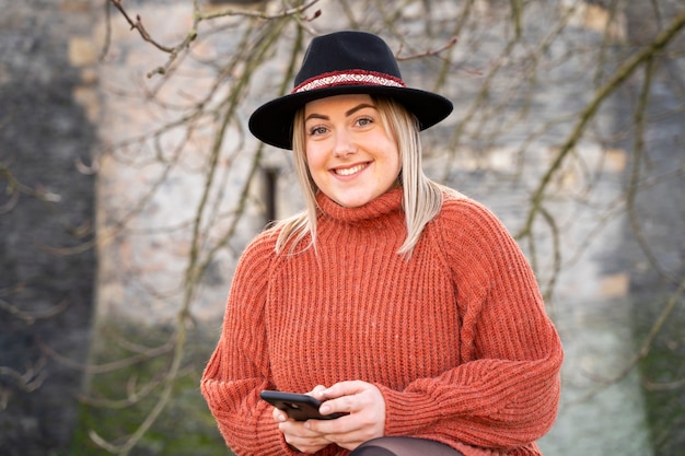 Beautiful french woman with a smart phone in her hands