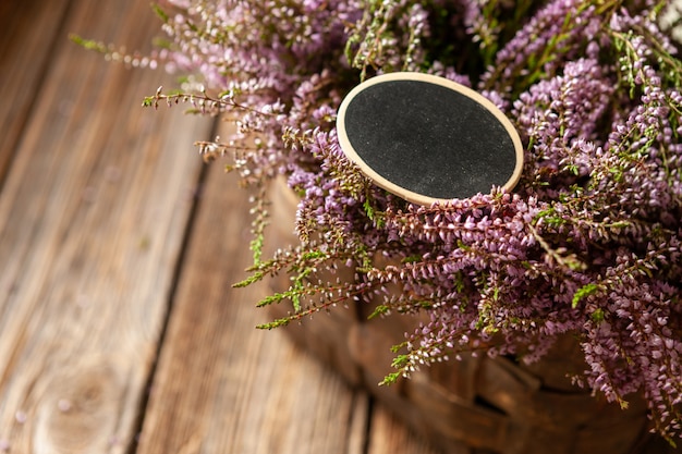 Beautiful fresh bouquet of blooming forest heather in basket 