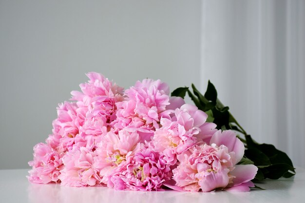 Beautiful fresh cut bouquet of pastel pink peony flowers in full bloom