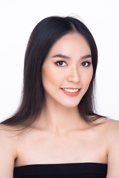 Beautiful fresh skin woman open shoulder with clean look make up and long black hair Portrait young girl in attractive natural fashion face express feel smile show eye lip isolated white background