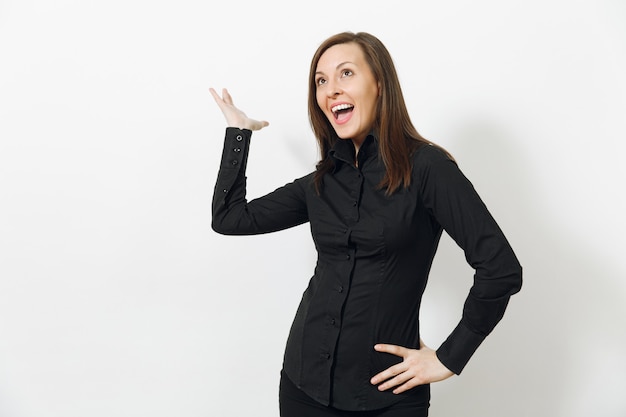 Beautiful fun happy caucasian young smiling brown-hair business woman in black classic shirt and skirt looking camera isolated on white wall