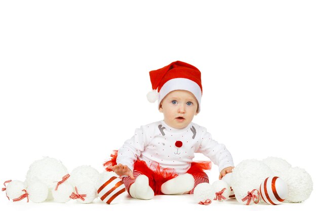 Beautiful funny baby in a christmas hat isolated on white