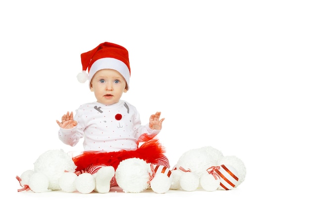 Beautiful funny baby in a christmas hat isolated on white