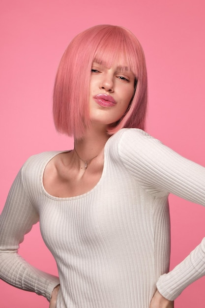 Beautiful funny cute woman in pink wig and classic makeup beauty face