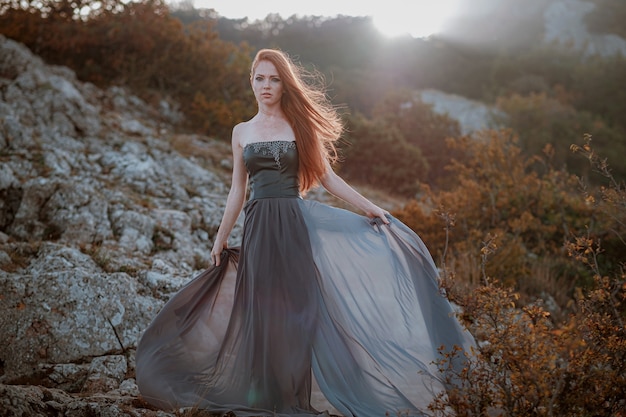 Beautiful furious scandinavian warrior ginger woman in grey dress