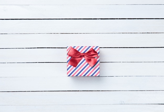 Beautiful gift box presents on white wooden background