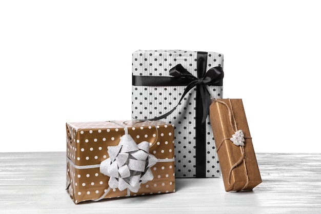 Beautiful gift boxes on table against white background