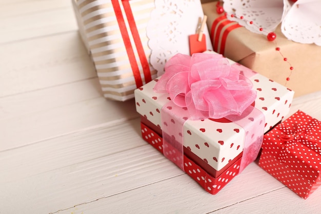 Beautiful gift boxes on wooden background. Valentine Day concept