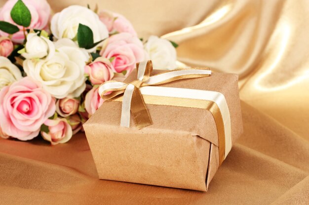 Beautiful gift on flowers background