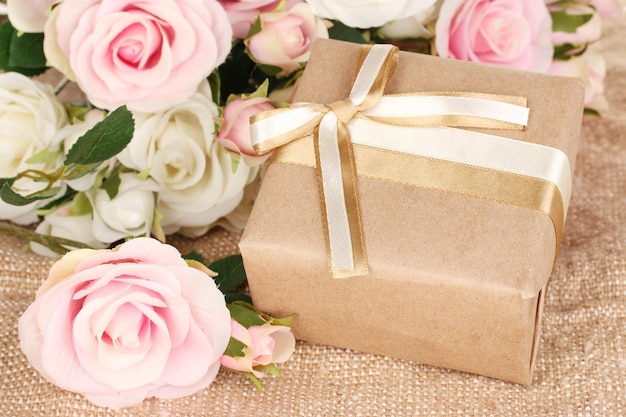 Beautiful gift on flowers background