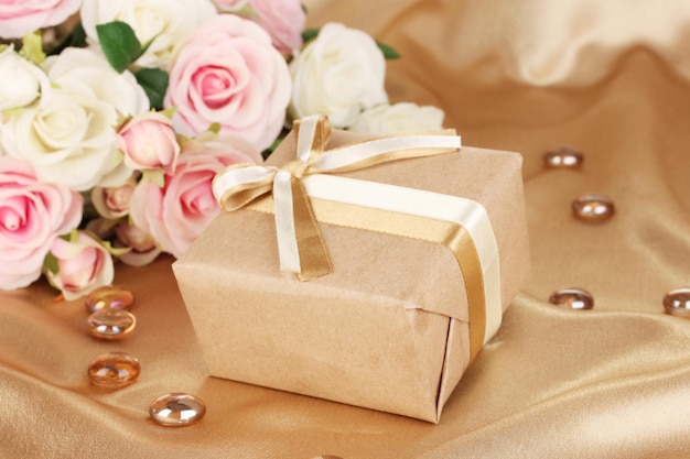 Beautiful gift on flowers background