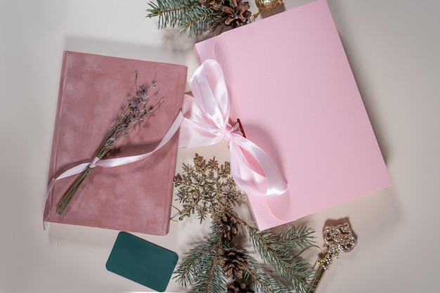 Beautiful gift pink cardboard box stars Christmas balls on beige background top view Flat lay New Year presents Festive decorations 2024 celebration Merry Christmas Happy Holidays card