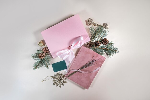 Photo beautiful gift pink cardboard box stars christmas balls on beige background top view flat lay new year presents festive decorations 2024 celebration merry christmas happy holidays card