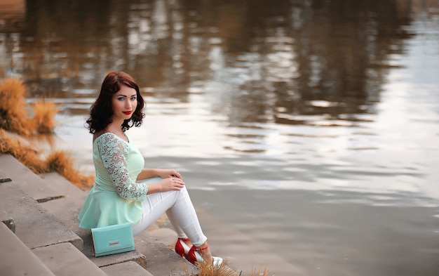 Beautiful girl in a autumn deciduous park in the afternoon