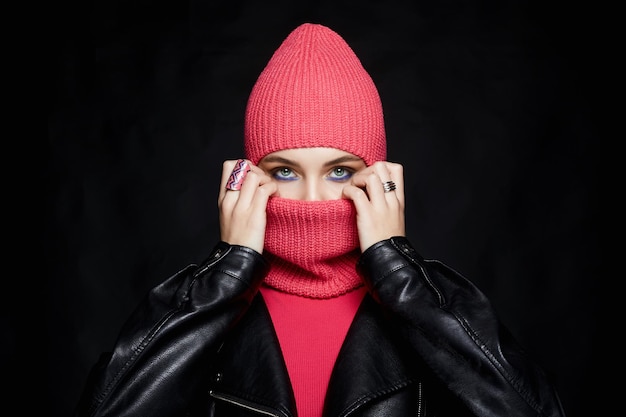 beautiful girl in balaclava and leather coat Trendy Mask on pretty woman