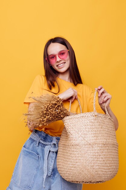 Beautiful girl Beach bag fashion in yellow tshirt denim shorts Lifestyle unaltered