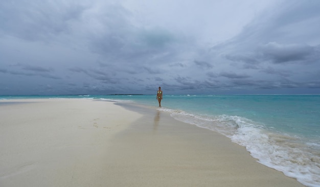 beautiful girl in a bikini on the seashore on the island