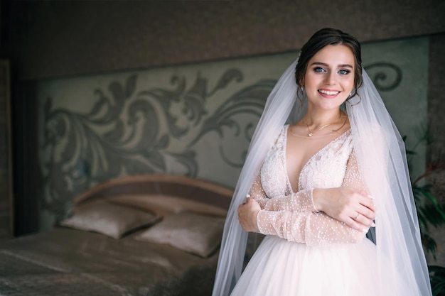 Of a beautiful girl of the bride in a long lace dress with an elegant hairstyle preparing for the wedding Morning gathering