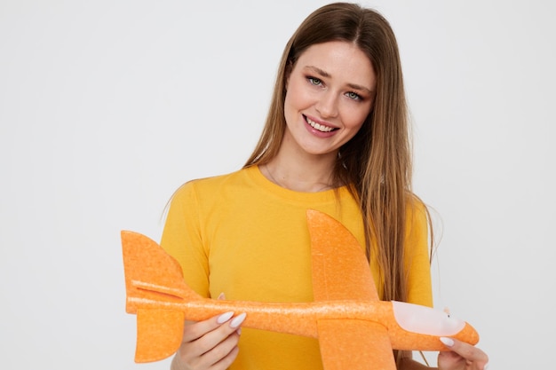 Beautiful girl in casual clothes an airplane in his hands Lifestyle unaltered