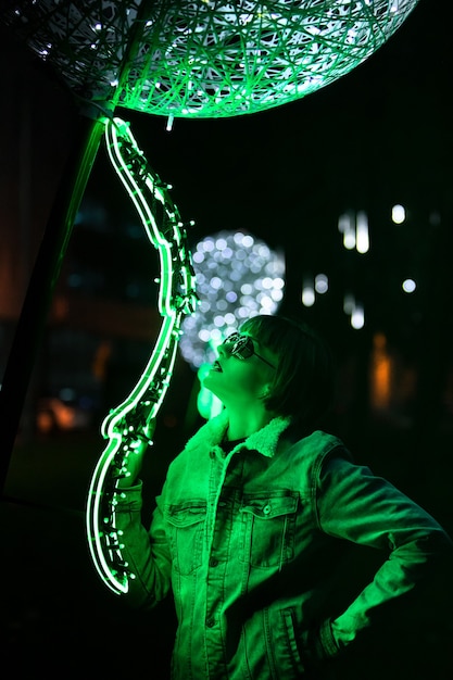 Beautiful girl for Christmas in glowing green lights