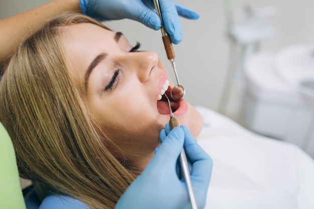 Photo beautiful girl at a dentist's review in a dental clinic.