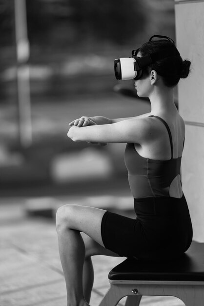 Beautiful girl doing pilates in the digital universe. Pilates reformer chair. Innovations. VR