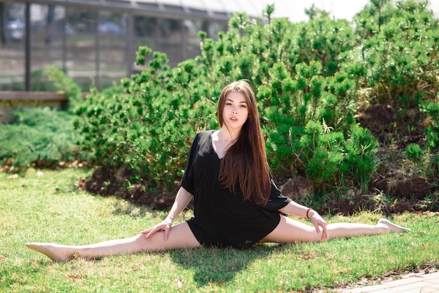 Beautiful girl doing stretching on nature