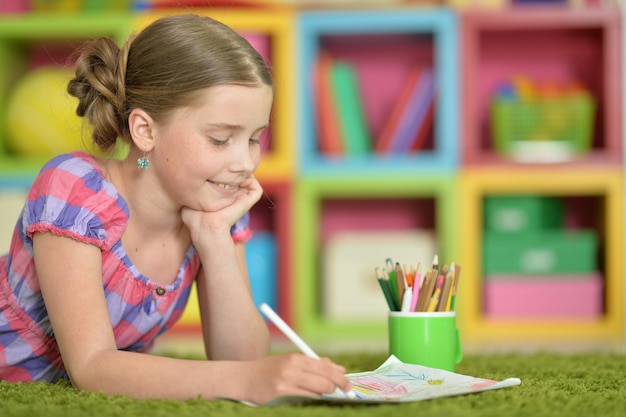 Beautiful girl drawing picture at home