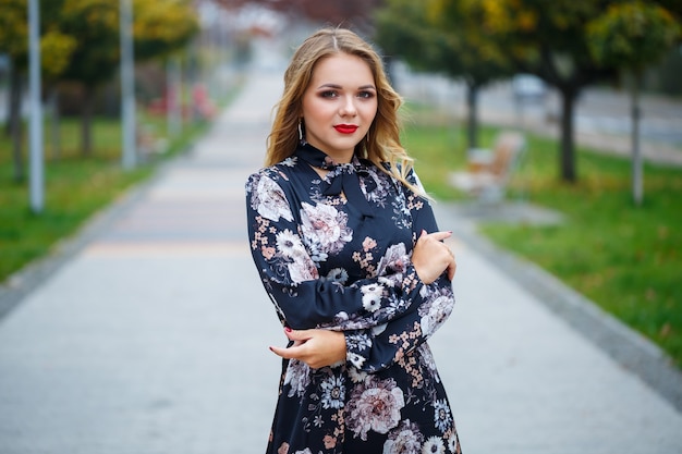 Beautiful girl in a dress on a city alley