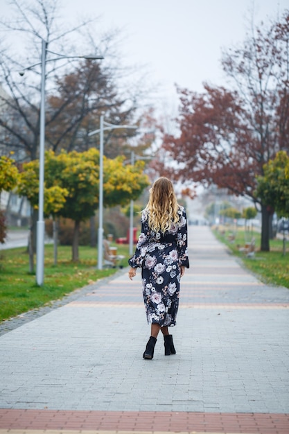 Bella ragazza in un vestito in un vicolo della città