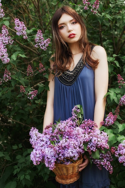 Beautiful girl in a dress posing near a Bush