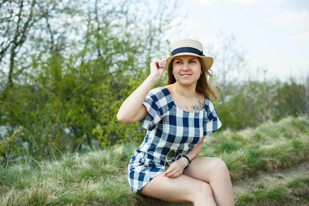 Beautiful girl in a dress walking in the spring forest where the trees bloom