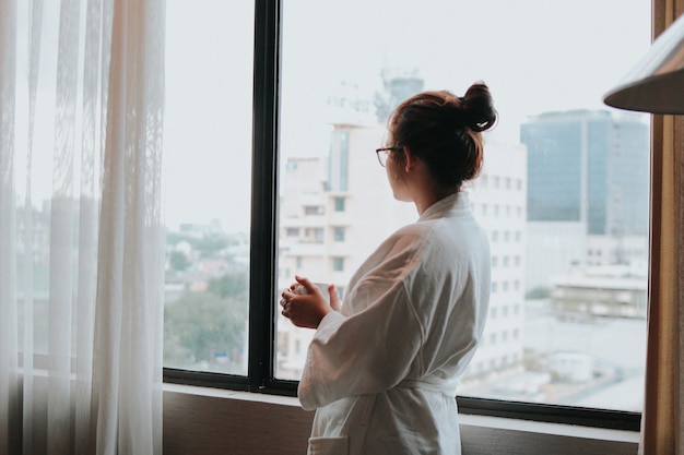 Beautiful girl drink a cup of coffee in the morning at hotel