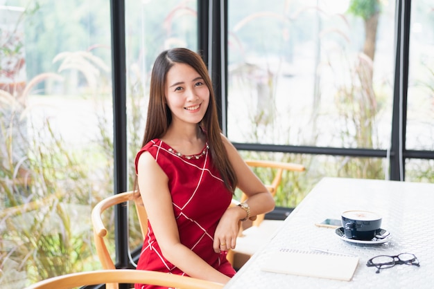 Beautiful girl drink hot coffee in the cafe