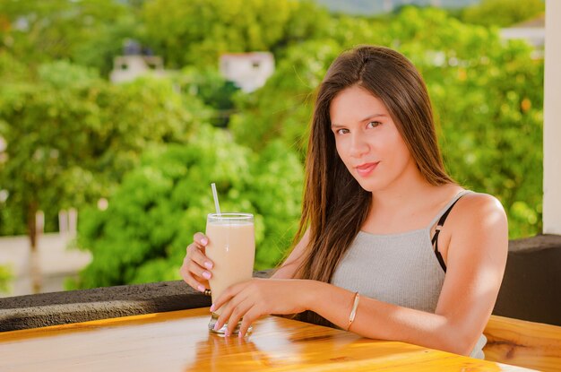 beautiful girl drinking in the table