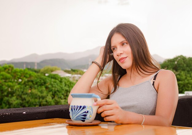 beautiful girl drinking in the table