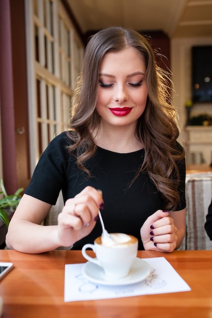 Beautiful girl drinks coffee