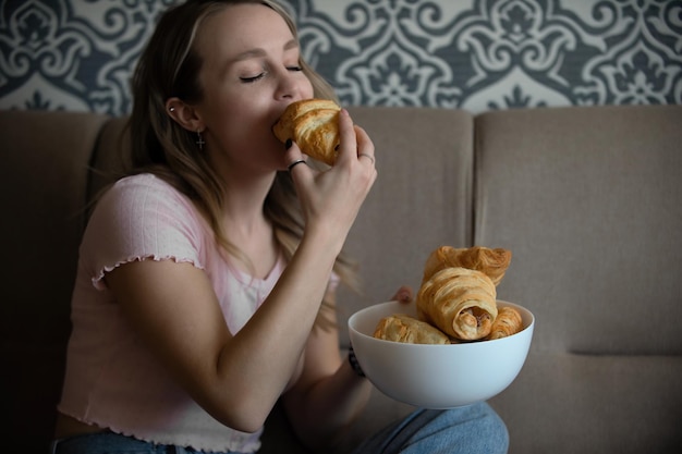 beautiful girl eating croissants