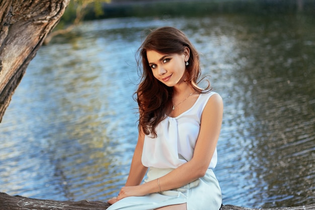 Beautiful girl in elegant dress in a natural park