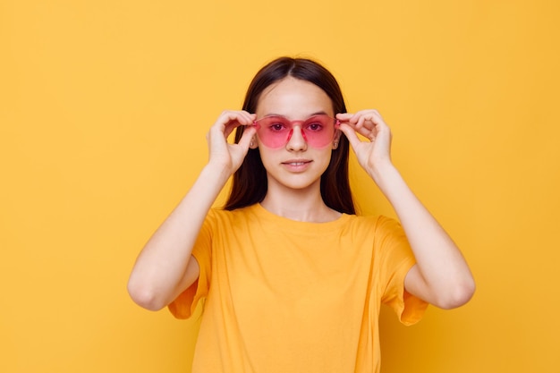 Beautiful girl fashion in yellow tshirt denim shorts isolated background