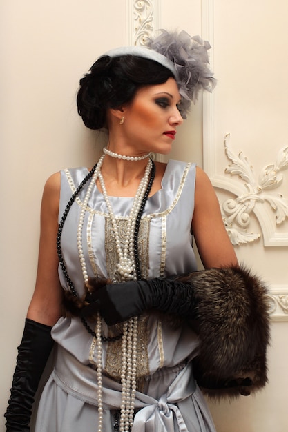 Beautiful girl in furs and pearls on the of the palace interiors