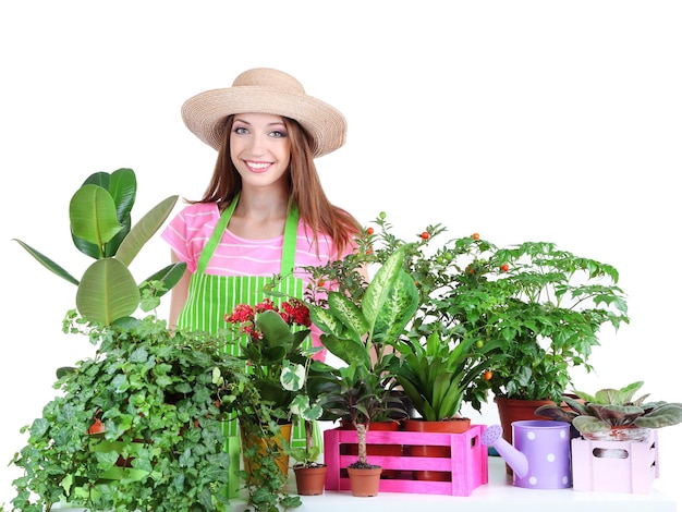 Beautiful girl gardener with flowers isolated on white