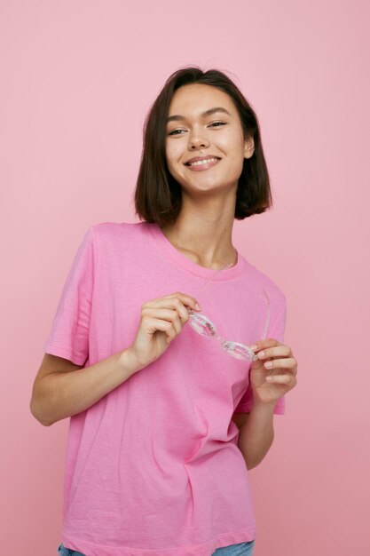 Beautiful girl glasses in the form of diamonds in a pink tshirt Lifestyle unaltered