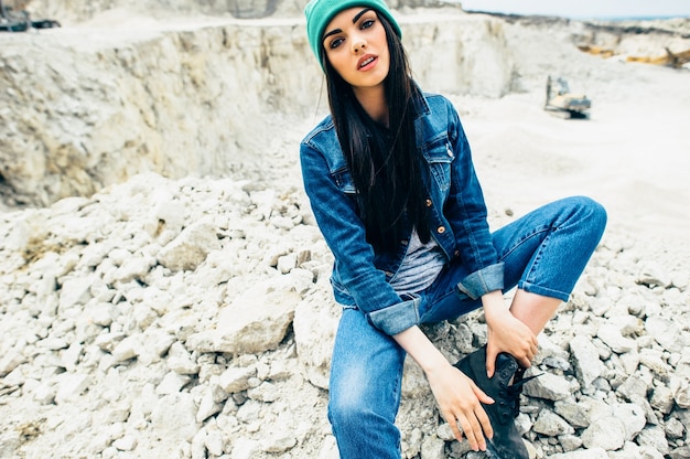 beautiful girl hipster model poses in quarry