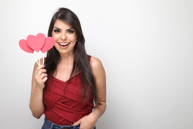 Beautiful girl holding valentine's gift on white background