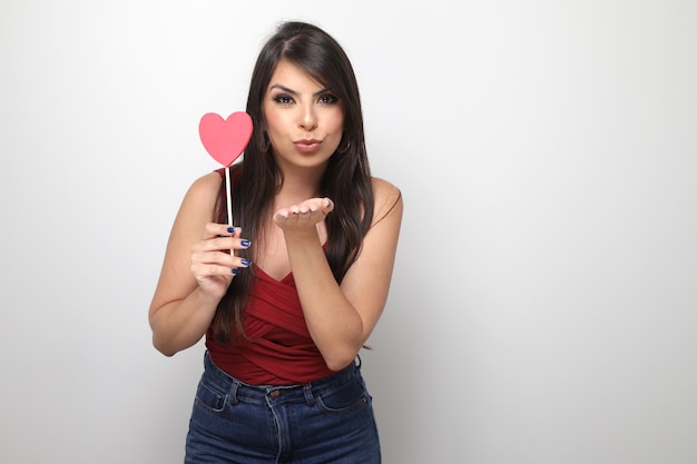 Beautiful girl holding valentine's gift on white background