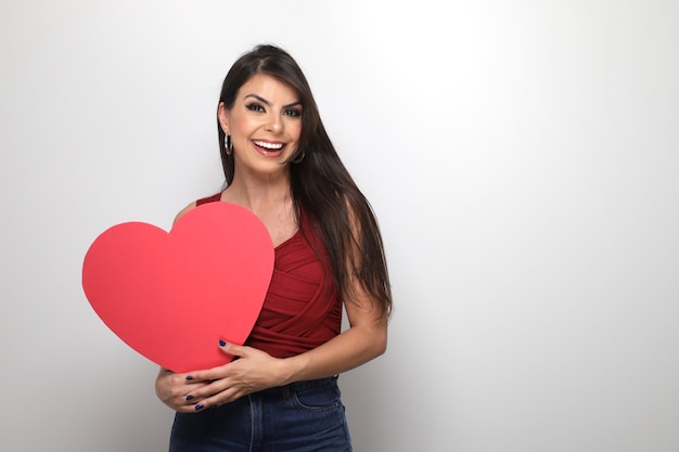 Beautiful girl holding valentine's gift on white background