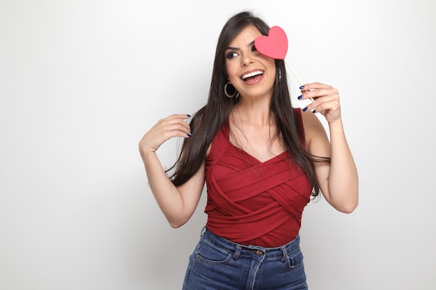 Beautiful girl holding valentine's gift on white background