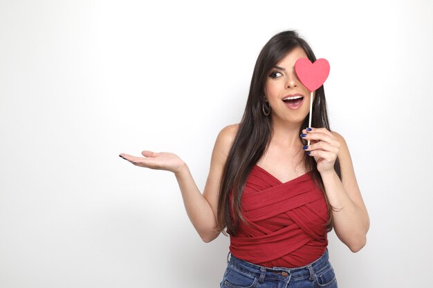 Beautiful girl holding valentine's gift on white background